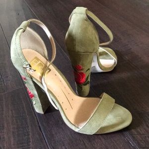 High heeled shoes with embroidered rose on heel.